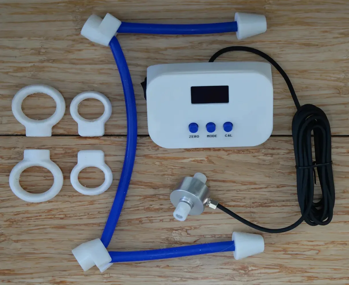 Splayometer Standard Kit laid flat: display unit, four finger rings, hand loop, load cell, and USB-C cable
