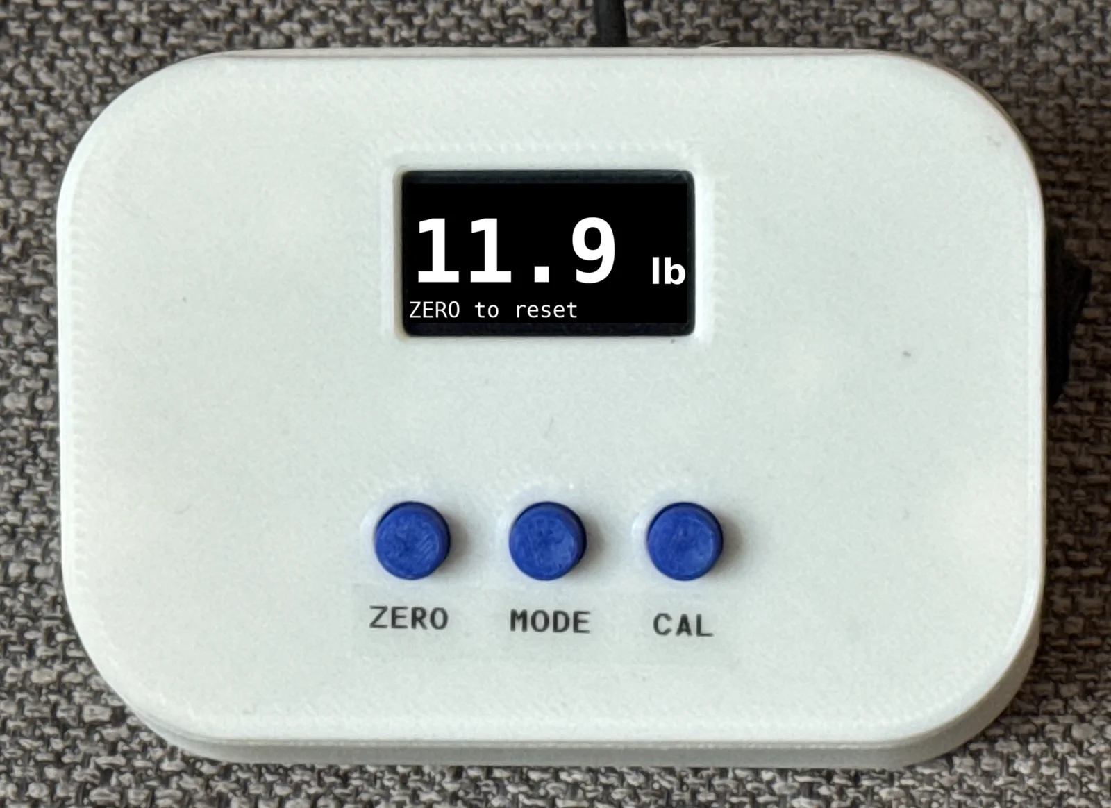Splayometer device with OLED display reading 11.9 lb in Max Hold mode